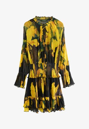 Bloemige jurk met lange mouwen in geel, zwart en groen. Kenmerkt een gerimpelde taille, gerafelde manchetten en een ronde halslijn met een strik.