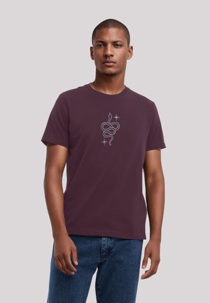 Maroon t-shirt with short sleeves, round neckline, and a silver snake design in the center, featuring stars and a smooth cotton texture.