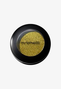 Produit cosmétique MAC dans un contenant rond noir avec un couvercle transparent, contenant des paillettes fines de couleur dorée vibrante.