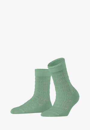 Mint green socks with a textured, patterned design. Ribbed cuff and reinforced toe. Lightweight, soft material for comfort.