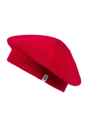 Bright red knitted wool beret with a small white tag featuring a black crest logo on the ribbed band.