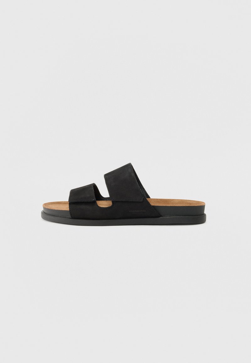 Black leather slide sandals with two wide straps, a cork footbed, and a textured rubber sole. Minimalistic design with no embellishments.