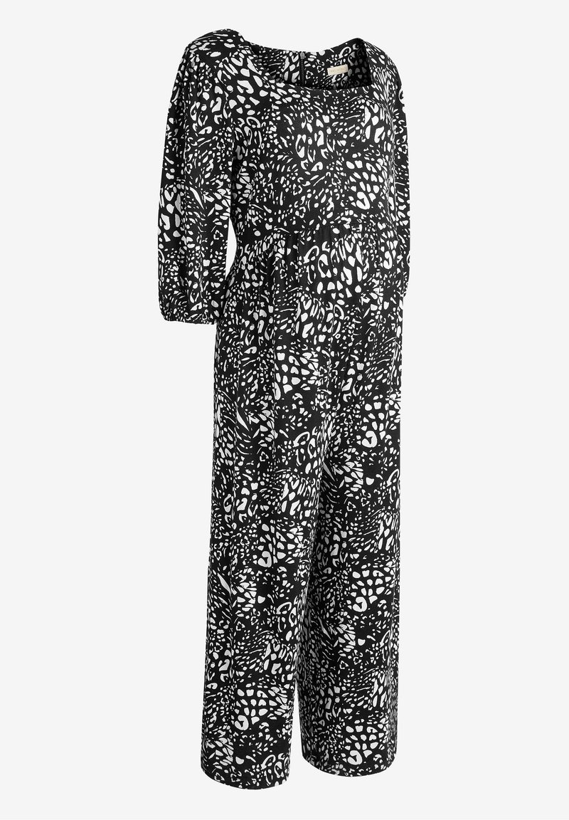 Mono de leopardo en blanco y negro con escote cuadrado, mangas de tres cuartos y piernas anchas. Fabricado en un tejido ligero con una textura suave.