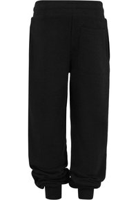 Pantalons de survêtement noirs en matériau doux, dotés d'une taille élastique, de poignets côtelés et d'une poche arrière unique. Design simple et coupe confortable.