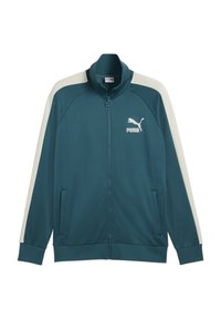 Teal jacka i mjukt tyg, med vita sidostråk, hög krage, dragkedja fram och logotyp på vänster bröst.