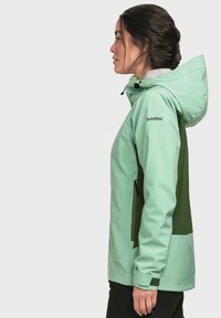 Green and mint waterproof jacket with a hood, zippered pockets, and adjustable features. Smooth texture, sporty design, logo on the arm.