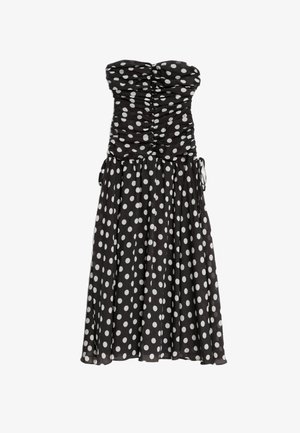Abito nero senza spalline con pois bianchi, corpetto arricciato e gonna fluida. Presenta lati con cordoncino per una vestibilità regolabile. Tessuto leggero.