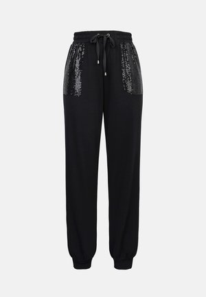 Pantalon de survêtement noir à coupe décontractée, avec des poignets élastiques et une ceinture à cordon. Poches avec accent en sequins argentés pour plus de détail.