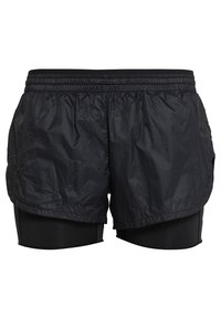 Svarta löparshorts med en lagerdesign; ytterlagret är gjort av lätt, krinklat tyg, medan innerlagret är åtsittande, stretchy och mjukt.