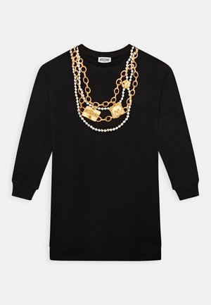 Svart sweatshirt med ett guld- och pärlkedjedesign på framsidan, med framträdande dekorativa detaljer och rund halsringning.