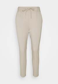 Pantalon beige effilé avec taille à cordon, deux plis à l'avant et texture lisse. Design simple sans motifs ni accents visibles.