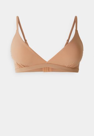 Nude fabric bralette with a triangular design, adjustable straps, and a smooth texture. Features a horizontal band at the back.