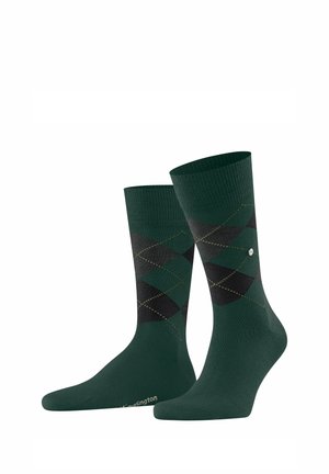 Grüne Socken mit einem schwarzen Rautenmuster und gelben Akzenten, mit gerippten Bündchen und einem Logo an der Spitze. Material: Baumwollmischung.
