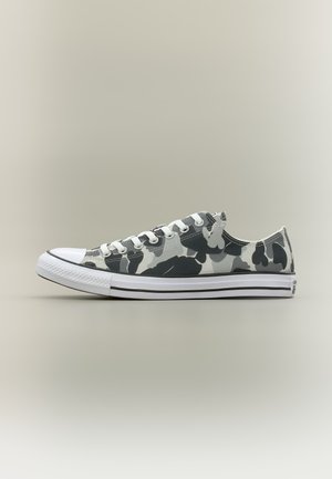 Low-top sneaker with white and gray camouflage pattern, white rubber toe cap, white laces, and white sole with black stripe.