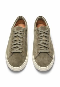Olive green suede sneakers with flat laces, round toe, and white rubber soles. Features embossed logo on tongue and leather lining.