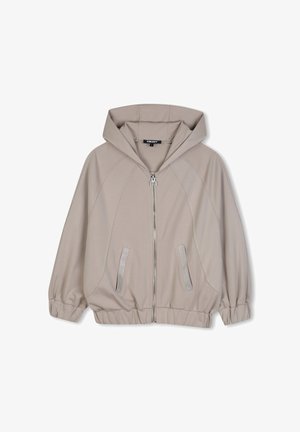 Veste à capuche beige clair avec fermeture éclair intégrale à l'avant, poignets et ourlet élastiques, deux poches avant, et logo DKNY sur la fermeture éclair et l'étiquette intérieure.