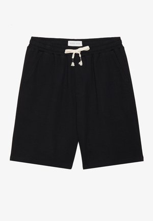 Shorts en coton noir avec une surface texturée, une taille élastique, un cordon de serrage avec des pompons, et deux poches latérales. Étiquette d'authenticité incluse.