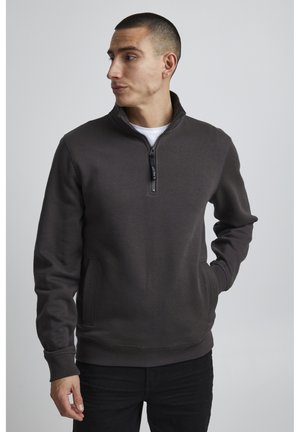 Dark gray zip-up sweatshirt with a high collar, long sleeves, side pockets, and ribbed cuffs and hem. Smooth texture, minimal design.
