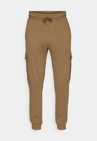 Bruna cargobyxor i mjukt tyg, med sidofickor, elastisk midja med dragsko och ribbade muddar.