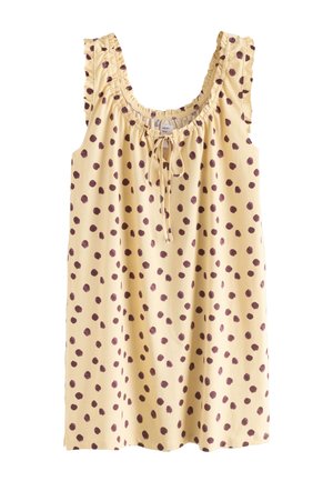 Robe beige sans manches avec des pois marron irréguliers, emmanchures volantées, encolure froncée et un nœud devant au col.