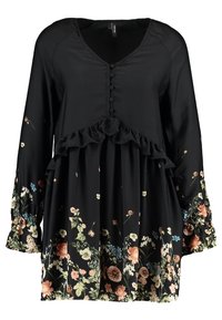 Svart blommig tunika med långa ärmar, volangkant, knappar framtill och en lös passform. Har färgglada blommönster i nyanser av rosa och blått.