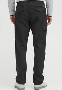 Black cargo pants made of cotton with two back pockets and side cargo pocket. The design features a straight fit and a durable texture.