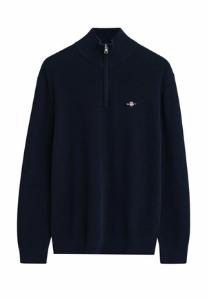 Sweater en tricot côtelé bleu marine avec de longues manches, col zippé quart et petit logo brodé sur la poitrine gauche.