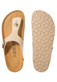 Sandalo con soletta in sughero color tan e tomaia sintetica crema, con accento circolare e fibbia regolabile. Suola in gomma testurizzata con motivo a onde.