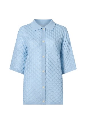 Cardigan court à manches courtes en tricot bleu clair avec motif en losanges texturé, col pointu et six boutons blancs sur le devant.