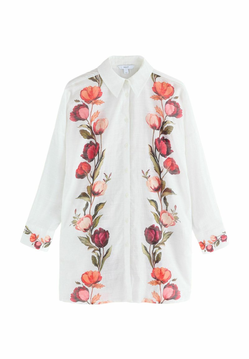 Balta pogājamā krekla izgatavota no linu, kas rotāta ar spilgtu ziedu izšuvumu rozā, sarkanā un zaļā krāsā gar priekšpusi un piedurknēm.