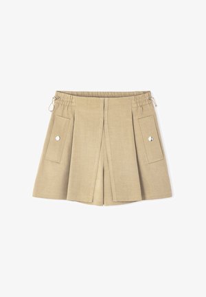 Beige linen shorts with an elastic waistband, two front pockets, and a pleated design. Features metal hardware accents for closure.