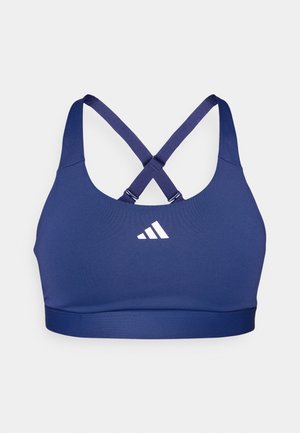 Námořnická sportovní podprsenka s přiléhavým střihem, zkříženými ramínky a bílým logem. Vyrobena ze strečového, vlhkost-odpudivého materiálu.