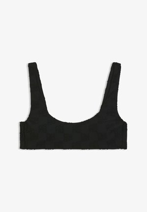 Schwarzes, kurz geschnittenes Tanktop mit breiten Trägern und dezent strukturiertem Muster auf dem Stoff, flach auf weißem Hintergrund präsentiert.