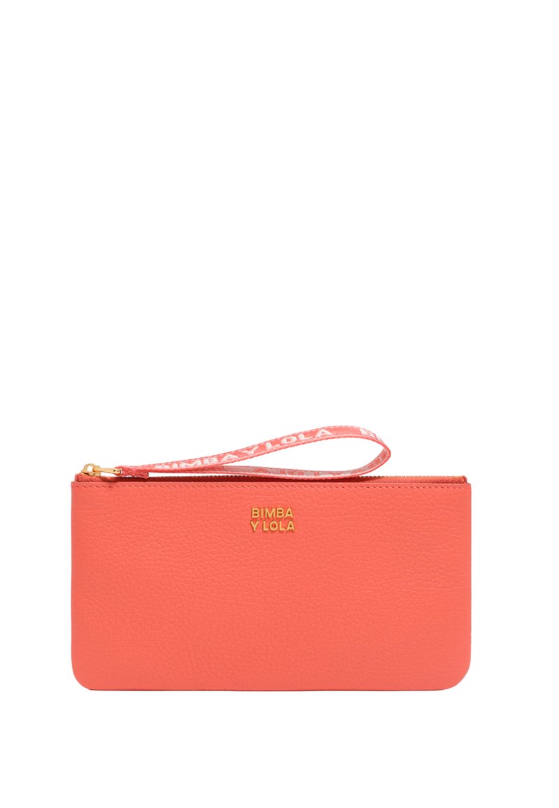 Coral leather wristlet with a smooth texture, gold logo, and zip closure. Features a fabric wrist strap with printed brand name.