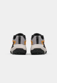 Chaussures de trail running avec une tige grise, des accents orange et une semelle en caoutchouc noir. Comprend un col rembourré et une semelle extérieure texturée pour l'adhérence.