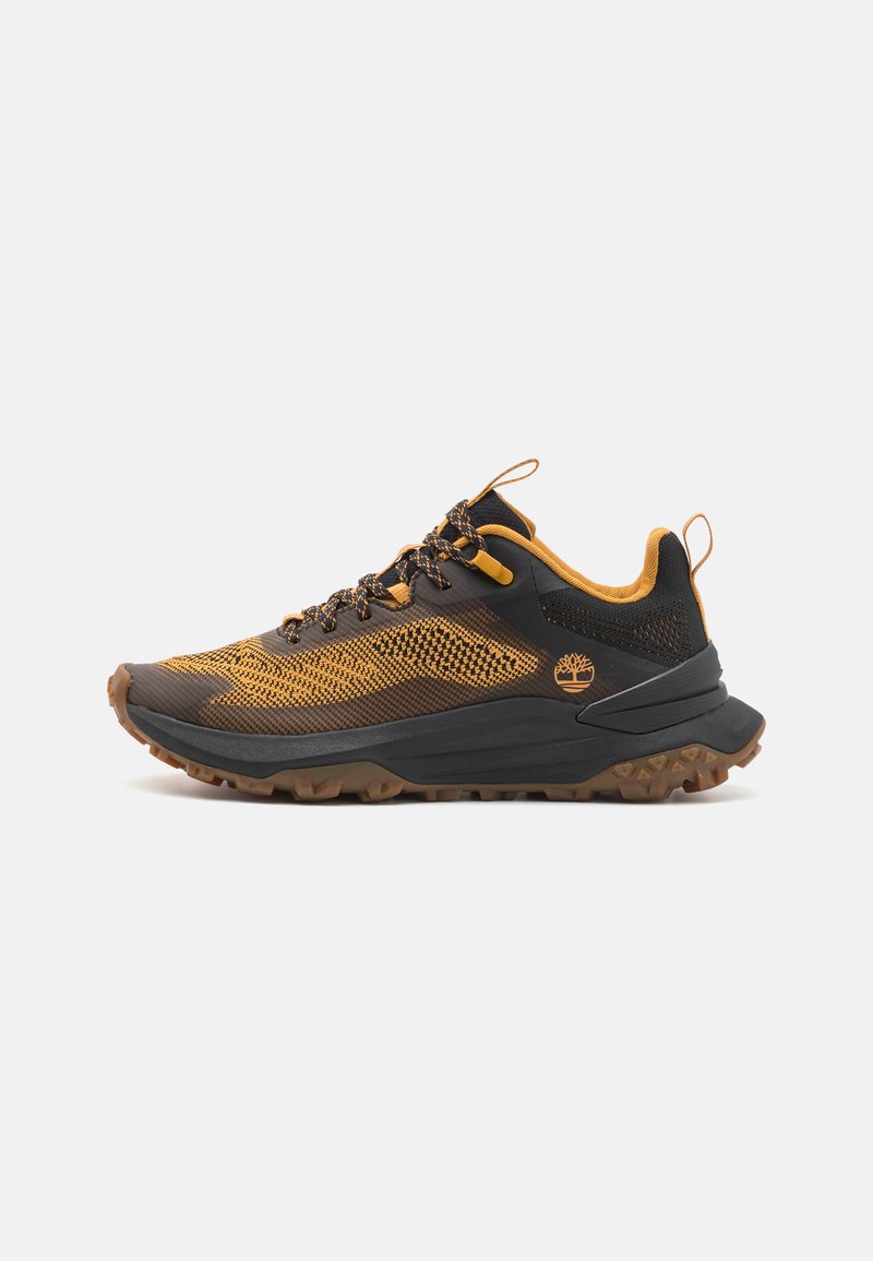 Black and yellow athletic shoes with a mesh upper, textured rubber sole, and reinforced toe. Features a logo on the side and contrasting laces.