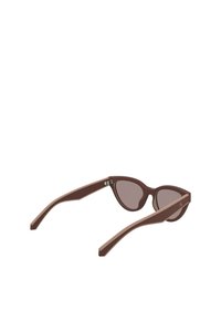 Brązowe plastikowe okulary przeciwsłoneczne w kształcie kocich oczu z gradientowymi soczewkami. Smukłe ramiona z jasnym akcentem i metalowym logo blisko zawiasu.