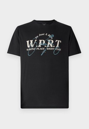 Black cotton t-shirt featuring white and teal graphic text that reads "W.P.R.T. WRONG PLACE RIGHT TIME" with a rounded neck and short sleeves.