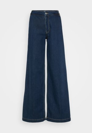 Džínsy s širokými nohavicami v tmavomodrej farbe, s vysokým pásom, gombíkovým zapínaním a jemnými švovým detaily pozdĺž švov.