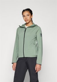 Helle grüne, leichte Jacke mit Kapuze, Frontreißverschluss und elastischen Bündchen. Auf dem linken Ärmeln befindet sich ein schwarzes Logo-Patch.