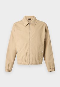 Μπεζ μπουφάν με φερμουάρ, μυτερό γιακά, πλαϊνές τσέπες με κουμπιά, ελαστικά μανίκια και ελαστική ραφή στο τελείωμα, σε μονόχρωμο φόντο.