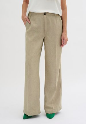 Pantalons large à taille haute beige en tissu texturé avec des flocons subtils. Comprend des poches avant, une fermeture à bouton et une coupe droite.
