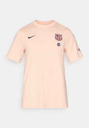 Men's short-sleeve T-shirt in light peach fabric. Features navy Nike logo and FC Barcelona crest on chest, with round neck design.