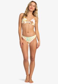 Bikini set featuring a multicolored floral pattern. The top has a V-neck design, and the bottoms have a low-rise cut in soft, stretchy fabric.