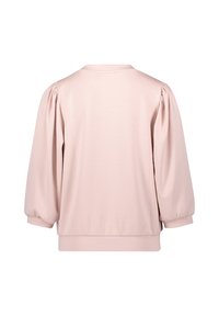 Blouse rose clair à manches longues avec manches bouffantes et poignets élastiques, vue de dos sur fond blanc.