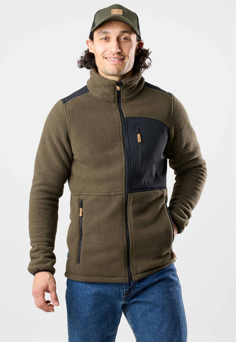 Fleecejacke in Olivgrün mit schwarzen Akzenten. Merkmale sind ein hoher Kragen, vordere Reißverschlusstaschen und ein strukturiertes Gewebe für Wärme und Komfort.