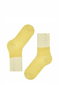 Gelbe gerippte Socken mit einem helleren gelben Bund. Weicher Stoff, standardmäßige Knöchellänge und ein verstärktes Zehendesign für Langlebigkeit.