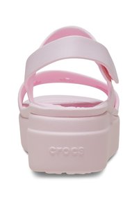 Pink Crocs sandal with two adjustable straps, a thick platform sole, and textured footbed. Branding embossed on the heel area.