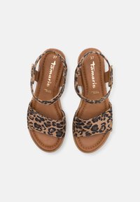 Leopard print sandals with brown leather straps, open toe design, and an adjustable ankle strap. Size 37 marked on insole.