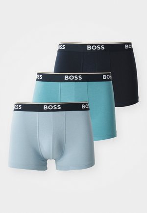 Three pairs of men's boxer shorts in light blue, teal, and navy. Each has a black waistband with white “BOSS” branding. Smooth texture.